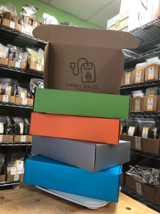 Four seasons gift boxes: blue = spring; silver = winter; orange = fall; green = summer with hinged lids and Summit Tea's rubber stamp on the inside cover