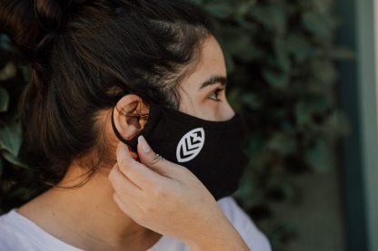 Woman adjusting Summit Tea Black Cloth Face Mask