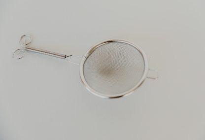 Side view of a small silver strainer